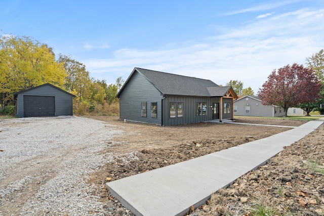 view of front of house with a garage and an outdoor structure