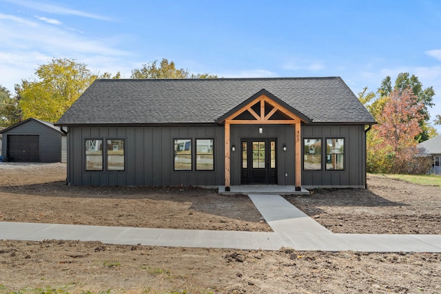 modern farmhouse style home featuring a garage and an outdoor structure