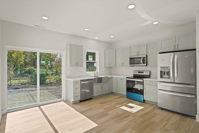 kitchen featuring sink, light hardwood / wood-style floors, and appliances with stainless steel finishes