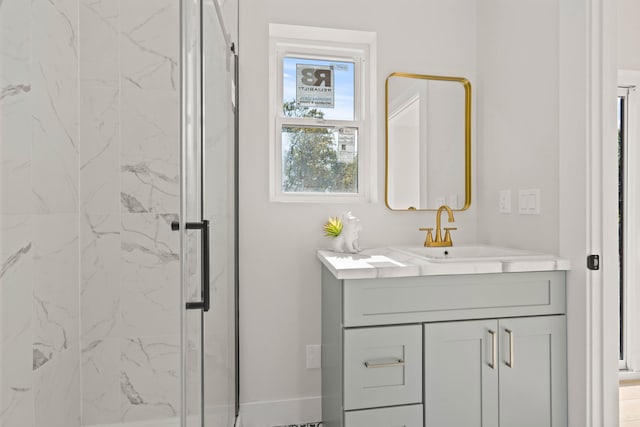 bathroom featuring vanity and a shower with shower door