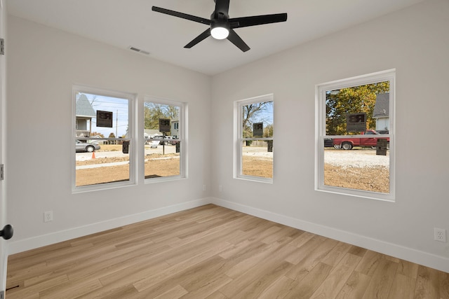 empty room featuring ceiling fan and light hardwood / wood-style floors