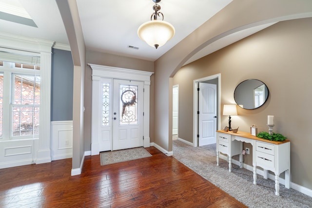 foyer entrance featuring dark hardwood / wood-style floors and a healthy amount of sunlight