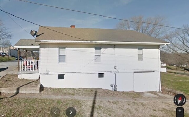 view of side of property with a porch