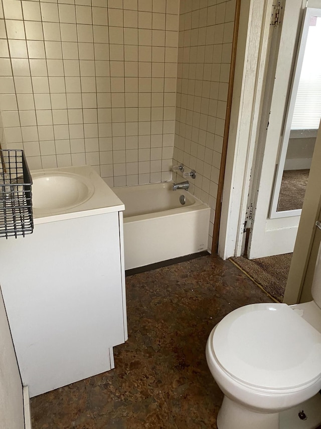 full bathroom with vanity, tiled shower / bath, and toilet