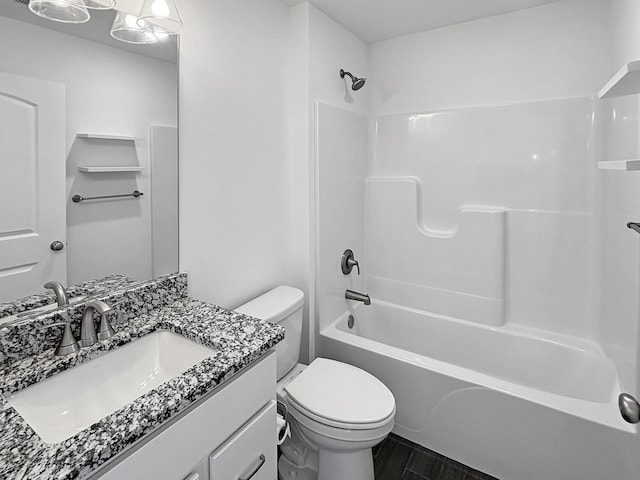 full bathroom with toilet, wood-type flooring, vanity, and  shower combination