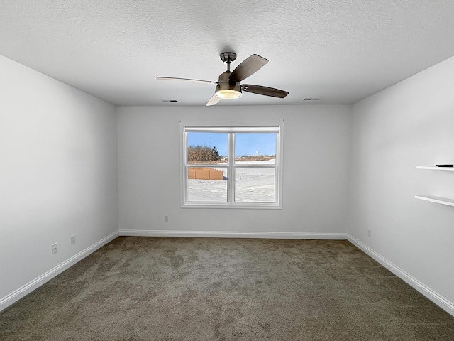 carpeted empty room with a textured ceiling and ceiling fan