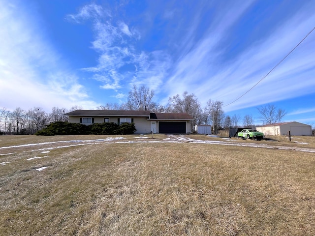 ranch-style home with a garage and a front yard