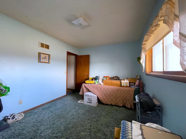 bedroom with dark colored carpet