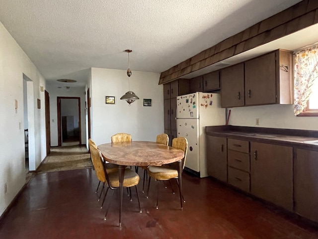 dining space featuring a textured ceiling