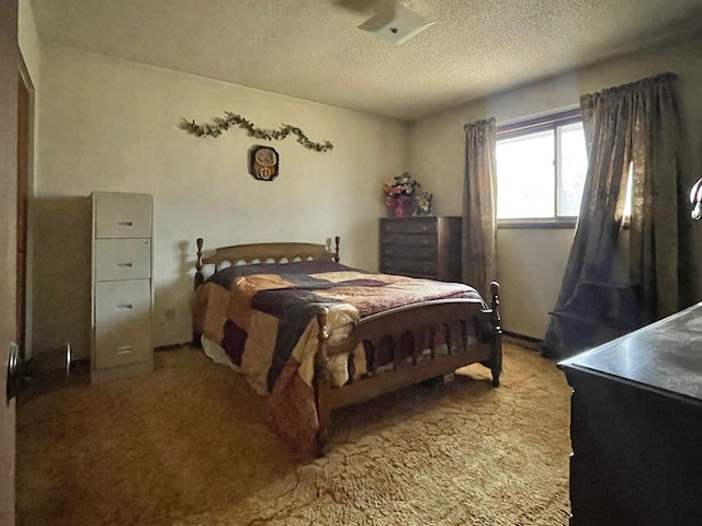 bedroom featuring carpet floors and a textured ceiling