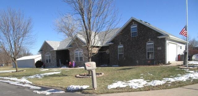 view of front of house with a garage and a lawn