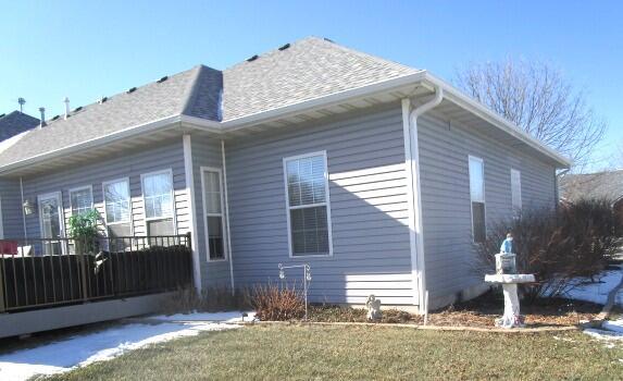 view of side of home with a lawn