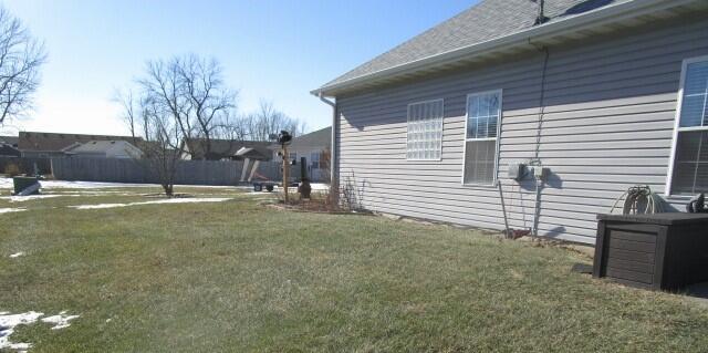 view of side of property with a lawn