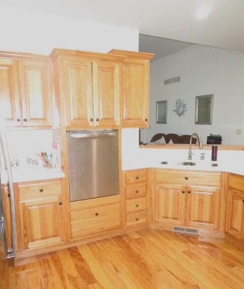 kitchen featuring refrigerator, sink, light brown cabinets, and light hardwood / wood-style floors