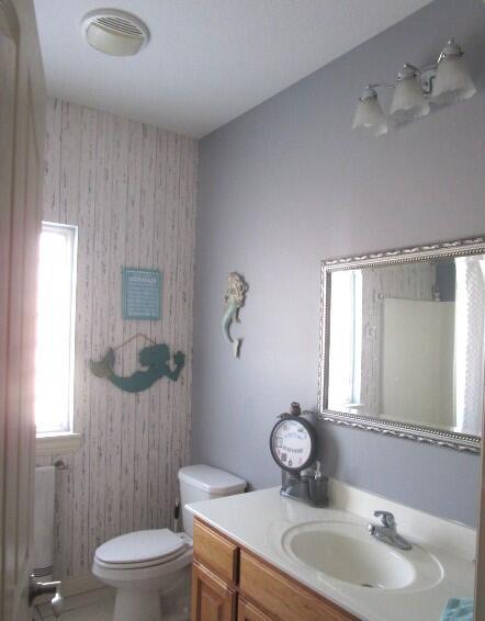 bathroom with vanity, tile patterned floors, and toilet