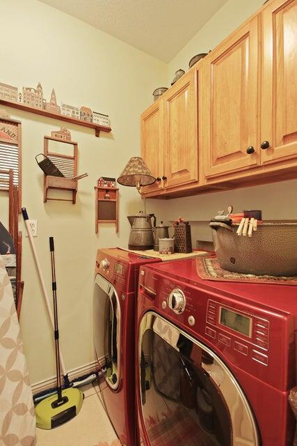 laundry area with cabinets and washing machine and dryer