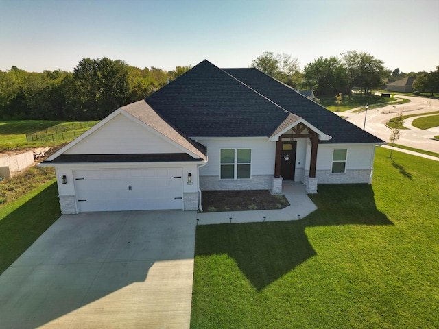 craftsman house with a garage and a front yard