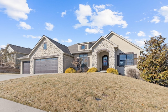 view of front of property featuring a garage and a front lawn