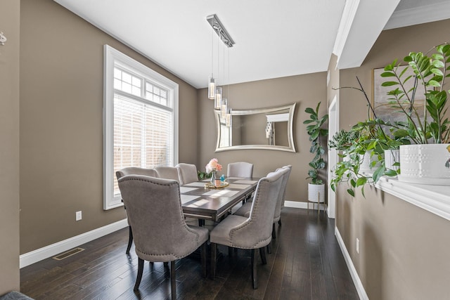 dining space with dark hardwood / wood-style flooring