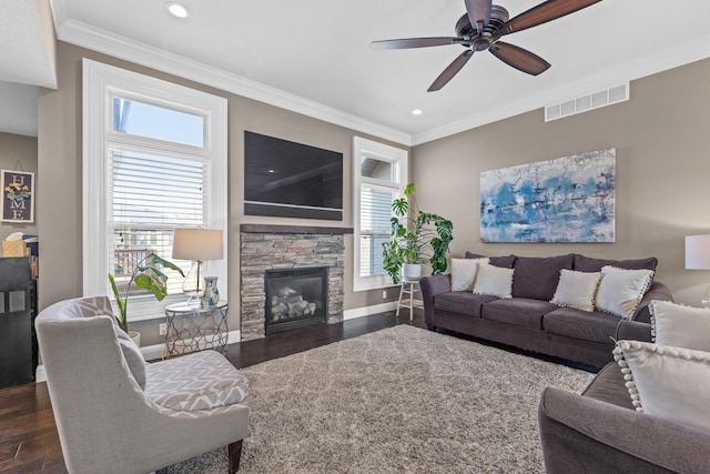 living room with crown molding, a healthy amount of sunlight, and dark wood-type flooring