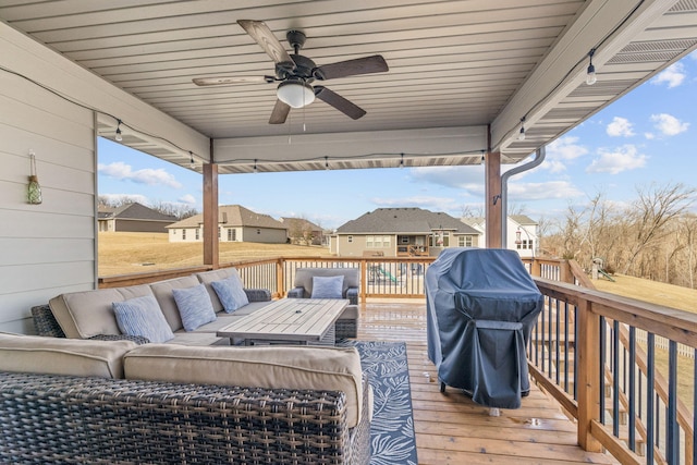 wooden terrace featuring an outdoor living space, area for grilling, and ceiling fan