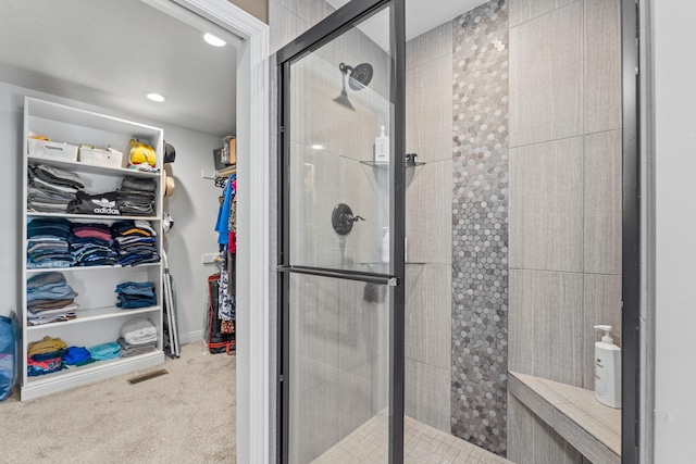 bathroom with a shower with door