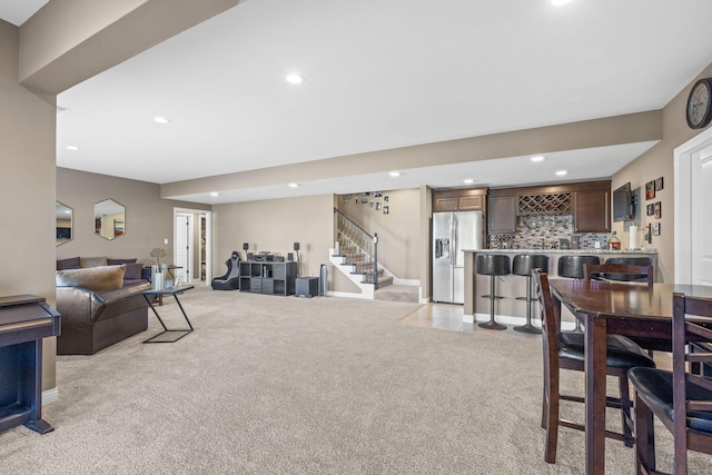 living room with bar area and light carpet