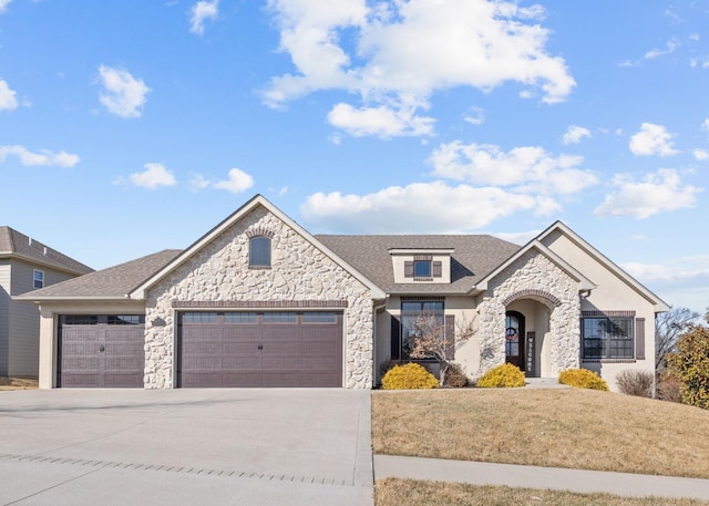 view of front of house with a garage and a front yard