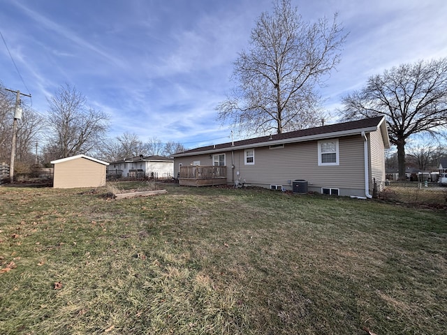 back of house with a wooden deck, a storage shed, a yard, and central AC unit