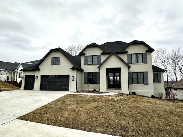 view of front of house with a garage, a front yard, and french doors