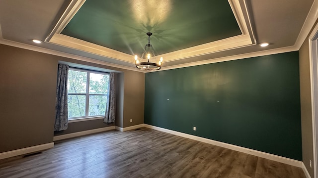 7333 Sella Ct, Columbia, MO 65203 - unfurnished room with a tray ceiling, crown molding, a chandelier, dark wood-style floors, and baseboards