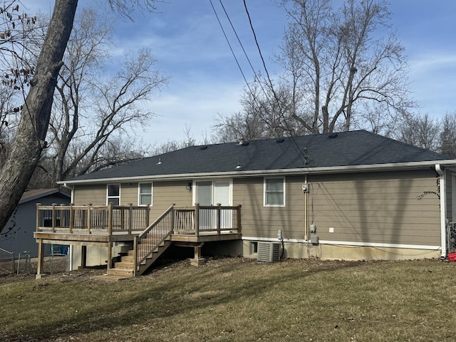 back of property featuring a deck, central air condition unit, and a lawn