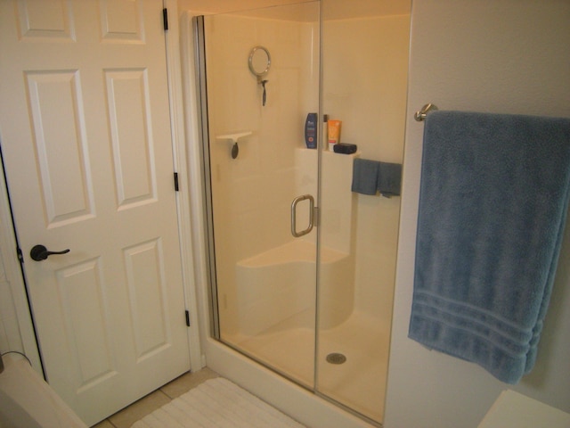 bathroom with tile patterned floors and walk in shower