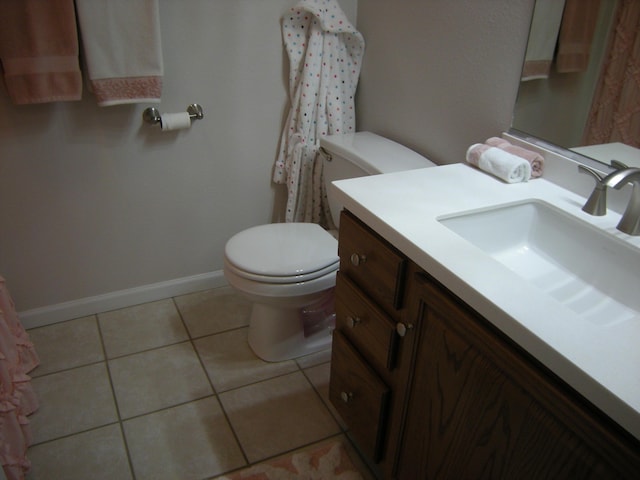 bathroom with vanity, tile patterned floors, and toilet