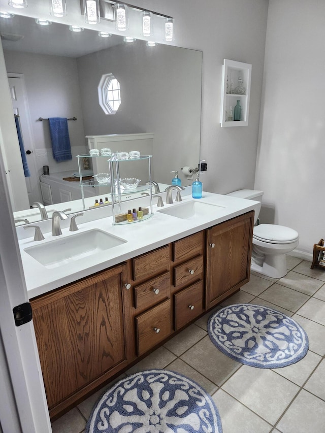 bathroom featuring tile patterned floors, toilet, and vanity