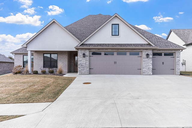 view of front of house with a garage and a front yard