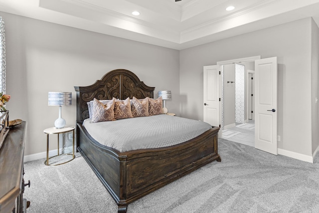 bedroom featuring crown molding, light colored carpet, and a raised ceiling