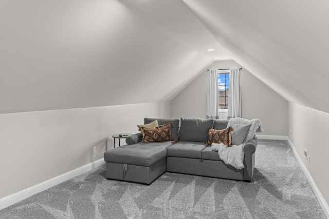 carpeted living room featuring vaulted ceiling