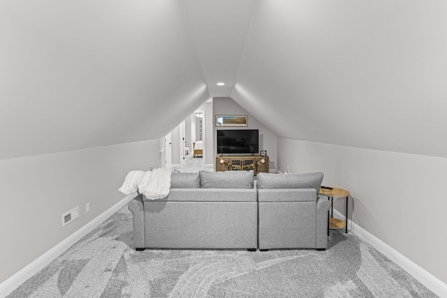 living room featuring vaulted ceiling and carpet floors