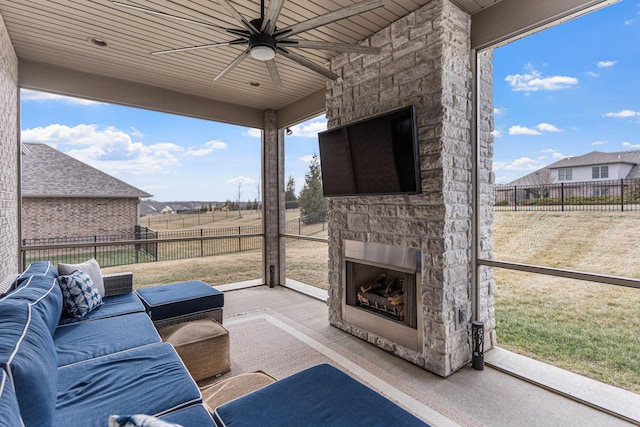 view of patio featuring ceiling fan and an outdoor stone fireplace