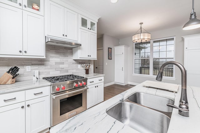 kitchen with white cabinetry, premium stove, decorative light fixtures, and light stone countertops