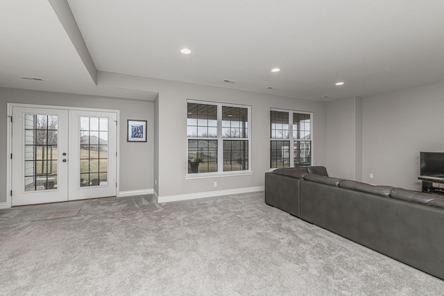 unfurnished living room featuring light colored carpet and french doors