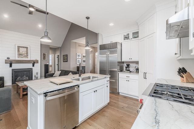 kitchen with white cabinetry, appliances with stainless steel finishes, sink, and hanging light fixtures