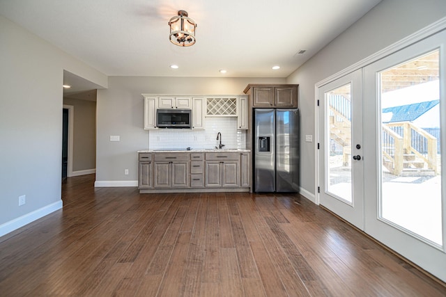 kitchen featuring sink, dark wood-type flooring, backsplash, stainless steel appliances, and french doors