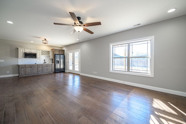 unfurnished living room featuring dark hardwood / wood-style flooring, french doors, and ceiling fan