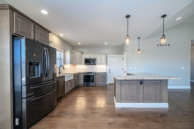 kitchen featuring sink, light stone counters, tasteful backsplash, dark hardwood / wood-style flooring, and stainless steel appliances