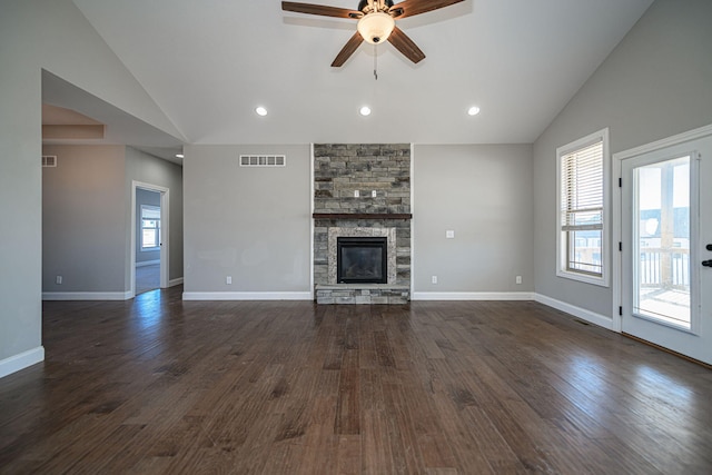 unfurnished living room featuring dark wood-type flooring, ceiling fan, a fireplace, and high vaulted ceiling