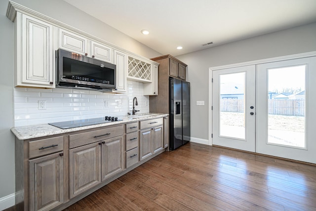 kitchen with french doors, sink, tasteful backsplash, dark hardwood / wood-style floors, and stainless steel appliances