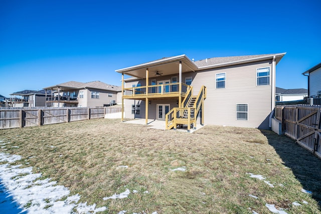 back of house with a patio, a wooden deck, ceiling fan, and a lawn