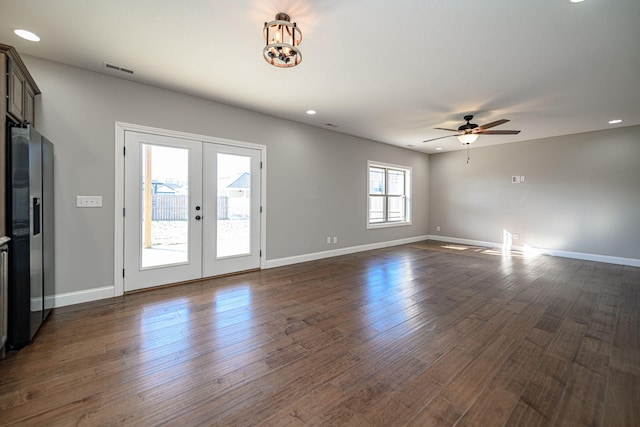 spare room featuring french doors, ceiling fan, and dark hardwood / wood-style floors